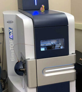 A large , vertical, rectangular blue and grey electronic machine in a lab.